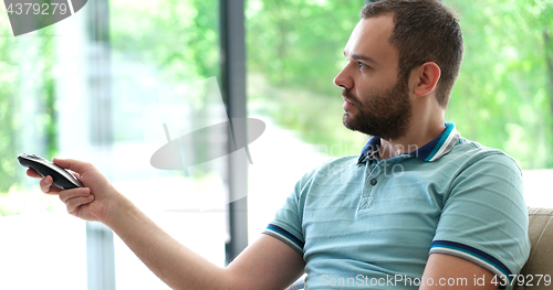 Image of Happy Man Watching Television