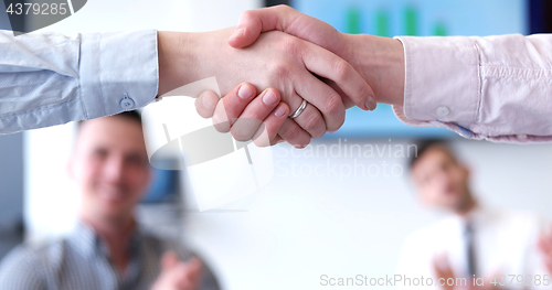 Image of cloasing the deal in modern office interior