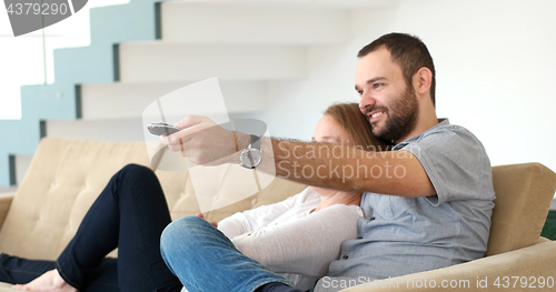 Image of senoior couple watching tv in modern villa