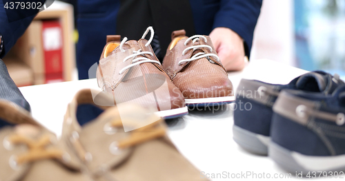 Image of Man Chooses Shoes At Shoe Store