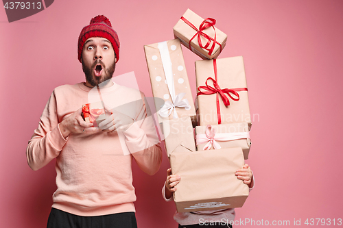 Image of Portrait of a surprised little girl with her father holding a Christmas present