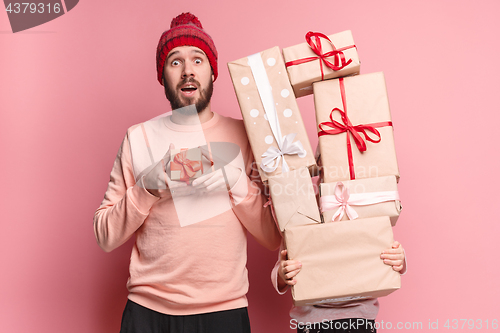 Image of Portrait of a surprised little girl with her father holding a Christmas present