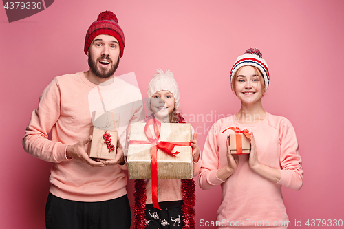 Image of Father and mother give gifts to little daughter at studio