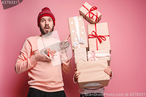 Image of Portrait of a surprised little girl with her father holding a Christmas present