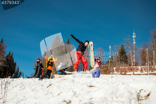 Image of Bukovel, Ukraine - December 22, 2016: Man boarder jumping on his snowboard against the backdrop of mountains, hills and forests in the distance. Bukovel, Carpathian mountains