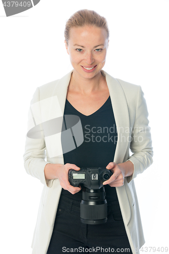 Image of Woman photographer takes images with dslr camera