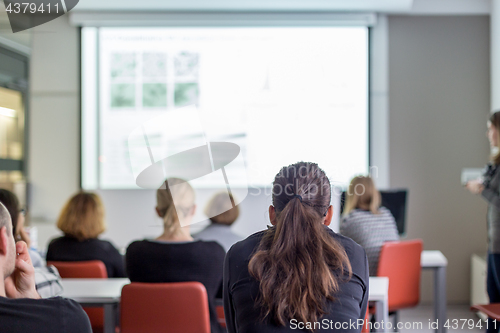 Image of Woman giving presentation on business conference.