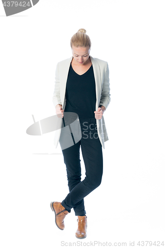 Image of Casual, relaxed, business woman looking down, standing against white background.