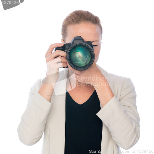 Image of Woman photographer takes images with dslr camera