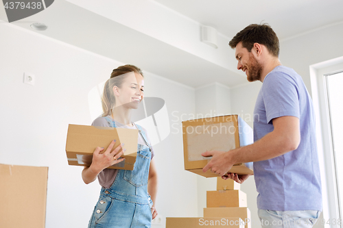 Image of happy couple with boxes moving to new home