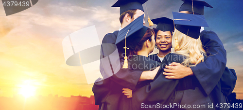 Image of happy students or bachelors hugging