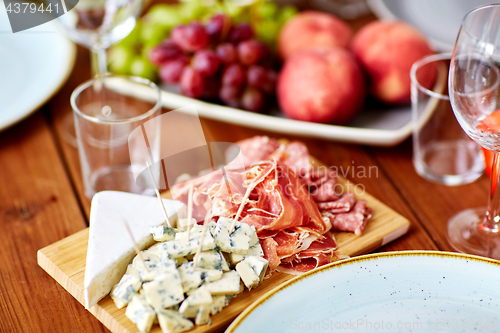 Image of blue cheese and jamon ham on wooden table