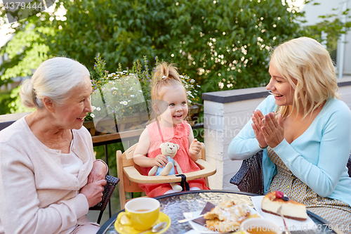 Image of mother, daughter and grandmother at cafe