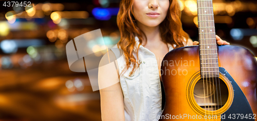 Image of close up of female musician with guitar