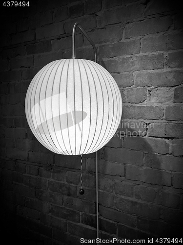 Image of Round wall lamp in black and white tones