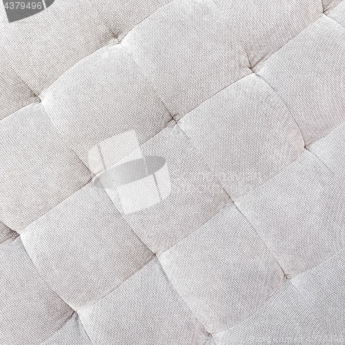 Image of Gray buttoned fabric background