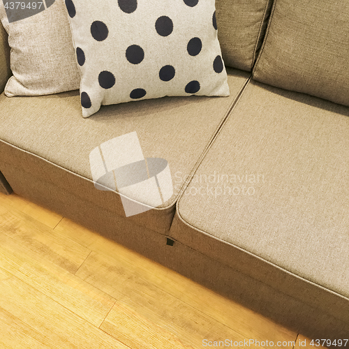 Image of Polka dot cushion decorating a textile sofa