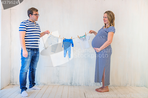 Image of Young couple: pregnant woman and man