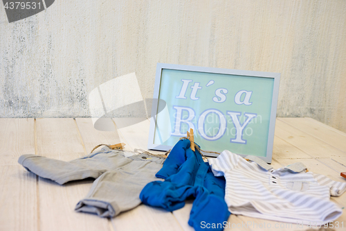 Image of Sign with text and baby clothes