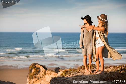 Image of Beautiful girls looking the beach