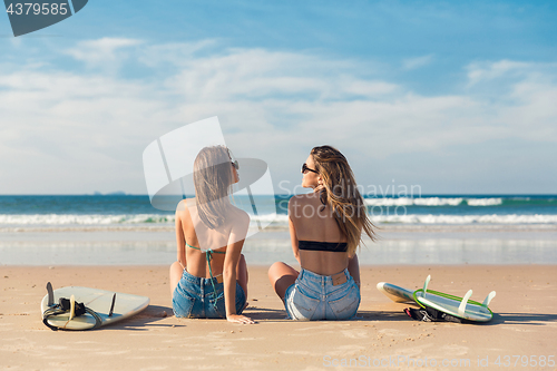 Image of Two surfer girls at the beach