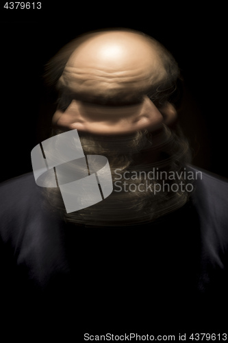 Image of motion blur portrait of a bearded bald head man