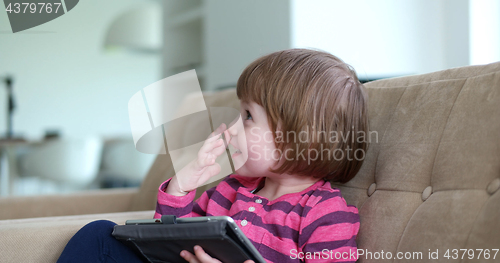 Image of Child using tablet in modern apartment