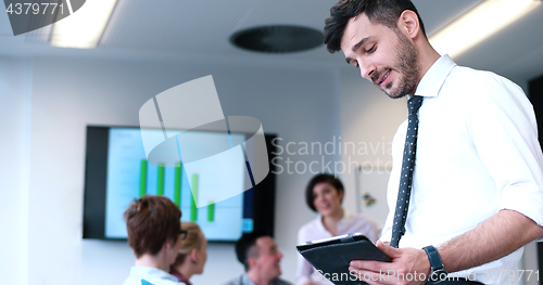 Image of Businessman using tablet in modern office