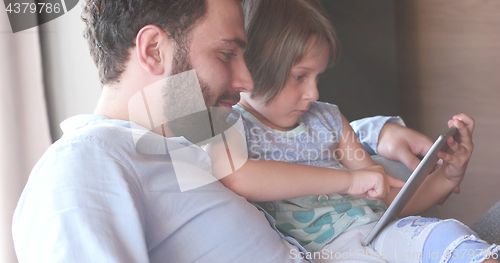 Image of Father Daughter using Tablet in modern apartment