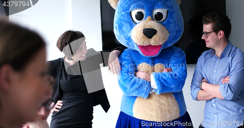 Image of boss dresed as bear having fun with business people in trendy of