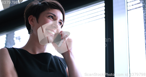 Image of Business Girl Standing In A Modern Building Near The Window With