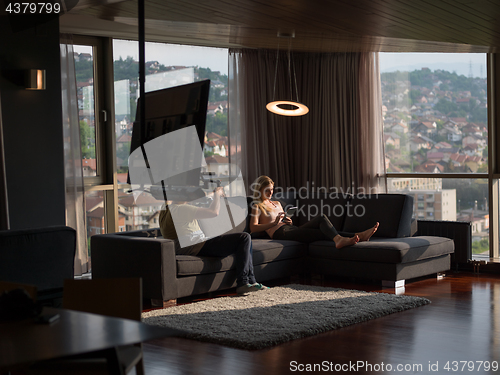 Image of Woman Using Tablet On Couch At Home