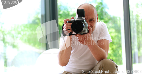 Image of Photographer takes pictures with DSLR camera