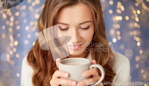 Image of close up of happy woman with coffee cup at home