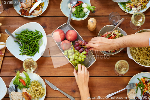 Image of group of people eating at table with food