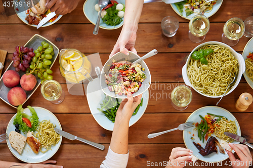 Image of people eating salad at table with food