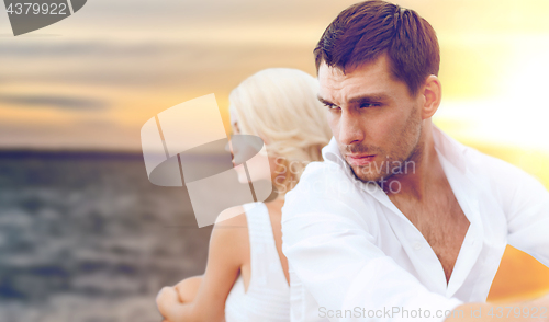 Image of unhappy couple over sea background