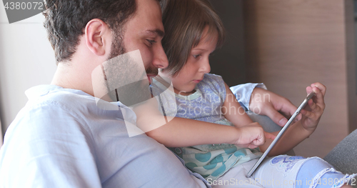 Image of Father Daughter using Tablet in modern apartment