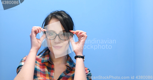 Image of woman smiling wearing on a pair of large glasses