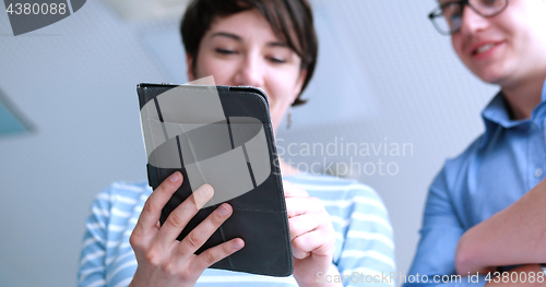 Image of low angle shot of business people using technology