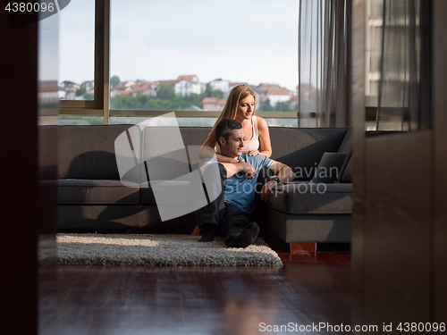 Image of Attractive Couple Using A Laptop on couch