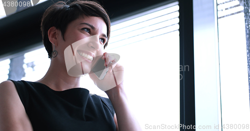 Image of Business Girl Standing In A Modern Building Near The Window With