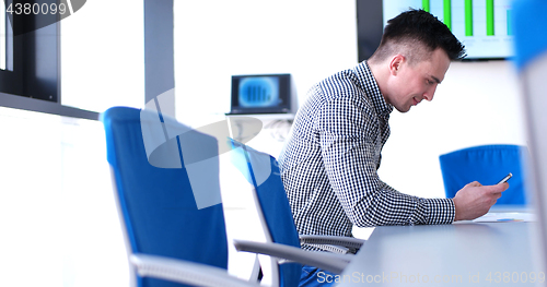 Image of Senior businessman  using cell phone at  stratup office