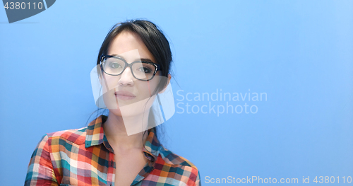 Image of woman smiling wearing on a pair of large glasses