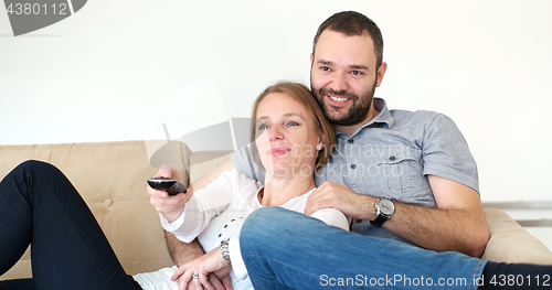 Image of senoior couple watching tv in modern villa