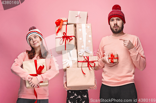 Image of Father and mother give gifts to little daughter at studio