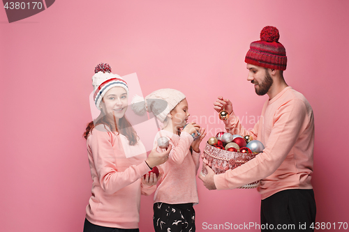 Image of Father and mother give gifts to little daughter at studio