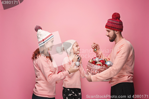 Image of Father and mother give gifts to little daughter at studio