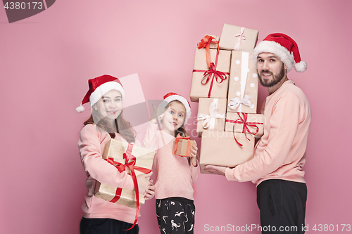 Image of Father and mother give gifts to little daughter at studio