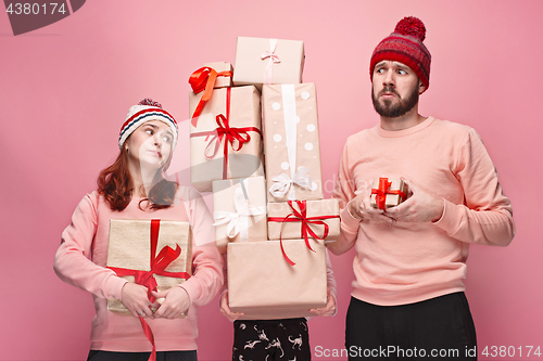 Image of Father and mother give gifts to little daughter at studio